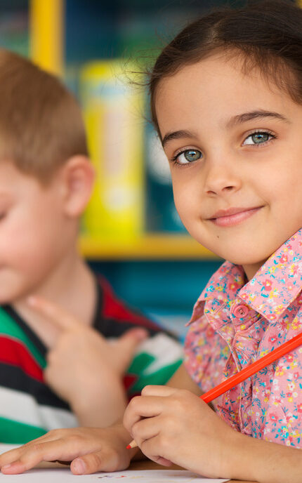 Cute little children drawing and studying at daycare