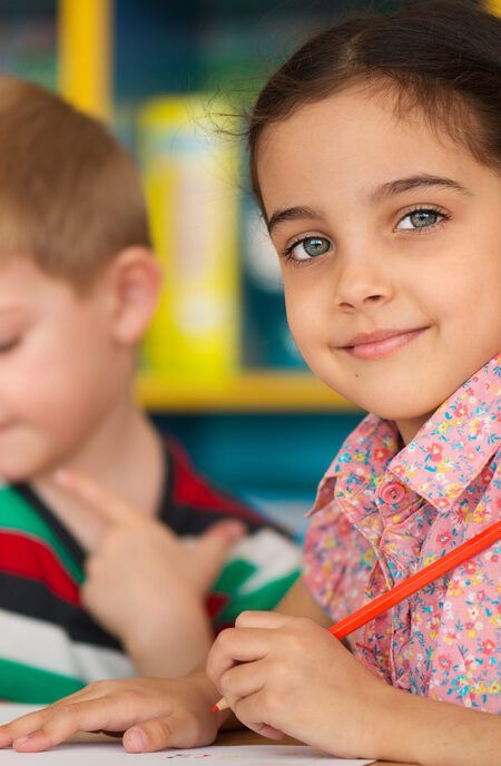 Cute little children drawing and studying at daycare