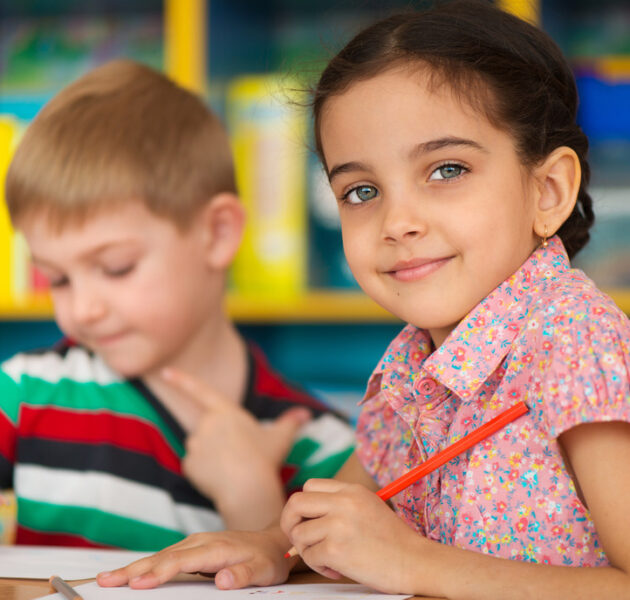 Cute little children drawing and studying at daycare